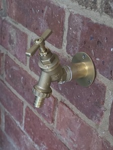 New brass outside garden tap installed on brick wall with copper pipe supply completed on 06-03-2026.